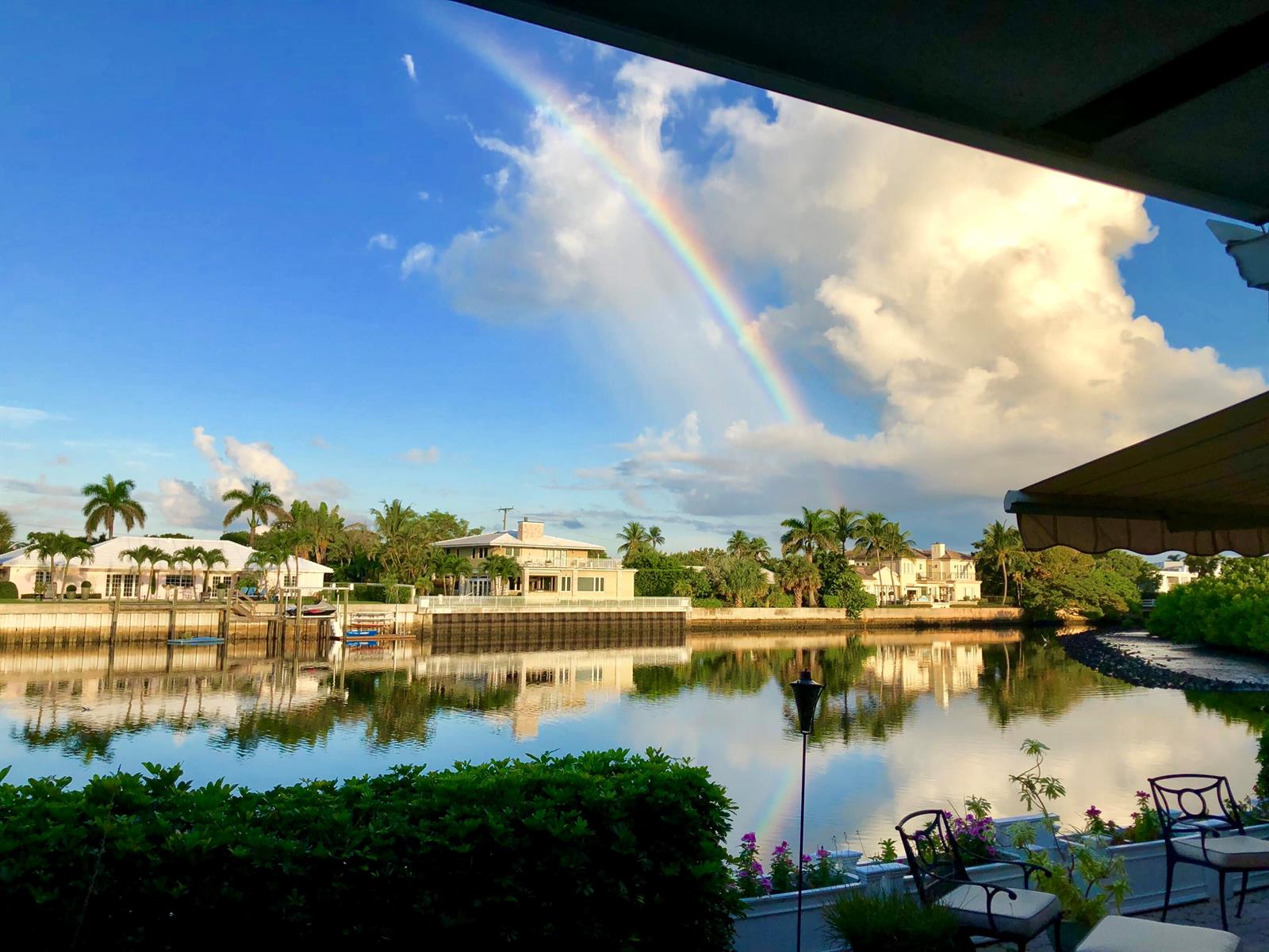 A rainbow arches over a calm canal lined with houses and palm trees — 2272 S Ocean Boulevard # T6, Palm Beach FL 33480, PALM BEACH, FL