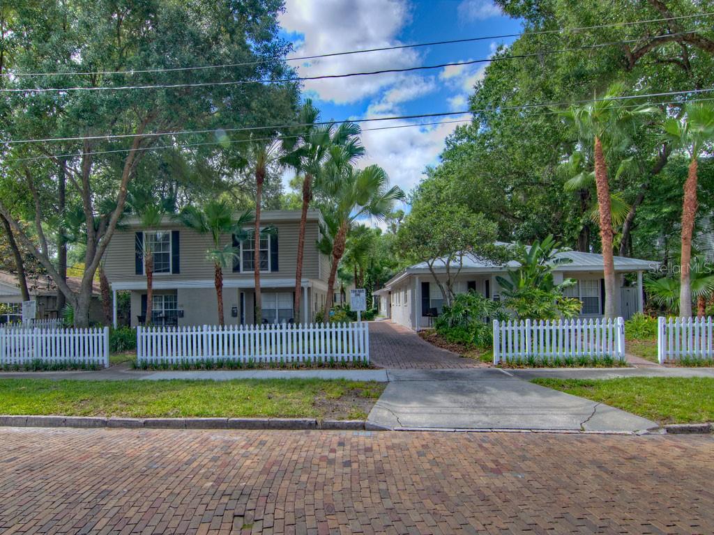 A two-story building and a single-story house sit behind a white picket fence — 616 PALMER STREET UNIT B, ORLANDO, FL
