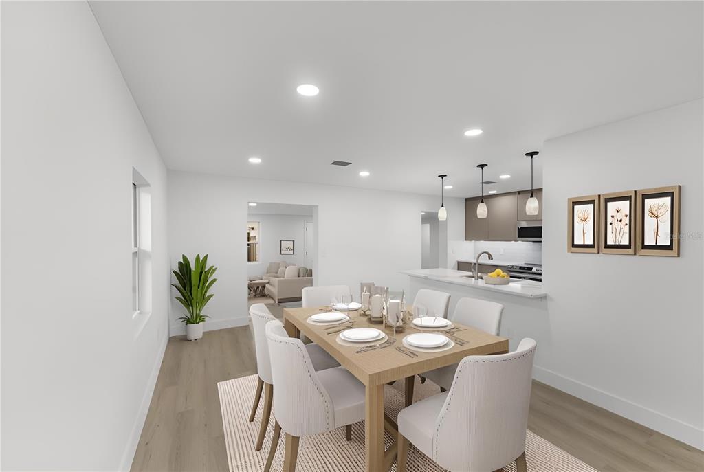 A dining room with a wooden table, six chairs, and an adjacent kitchen with island — 3118 PICKFAIR STREET, ORLANDO, FL