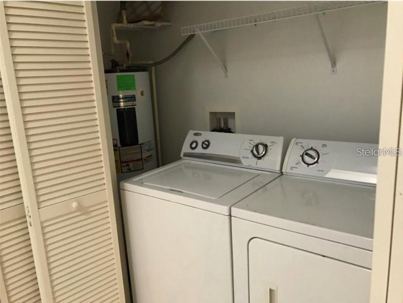 A laundry closet contains a white top-load washer, a dryer, and a water heater — 2792 CLUB CORTILE CIRCLE UNIT B, KISSIMMEE, FL