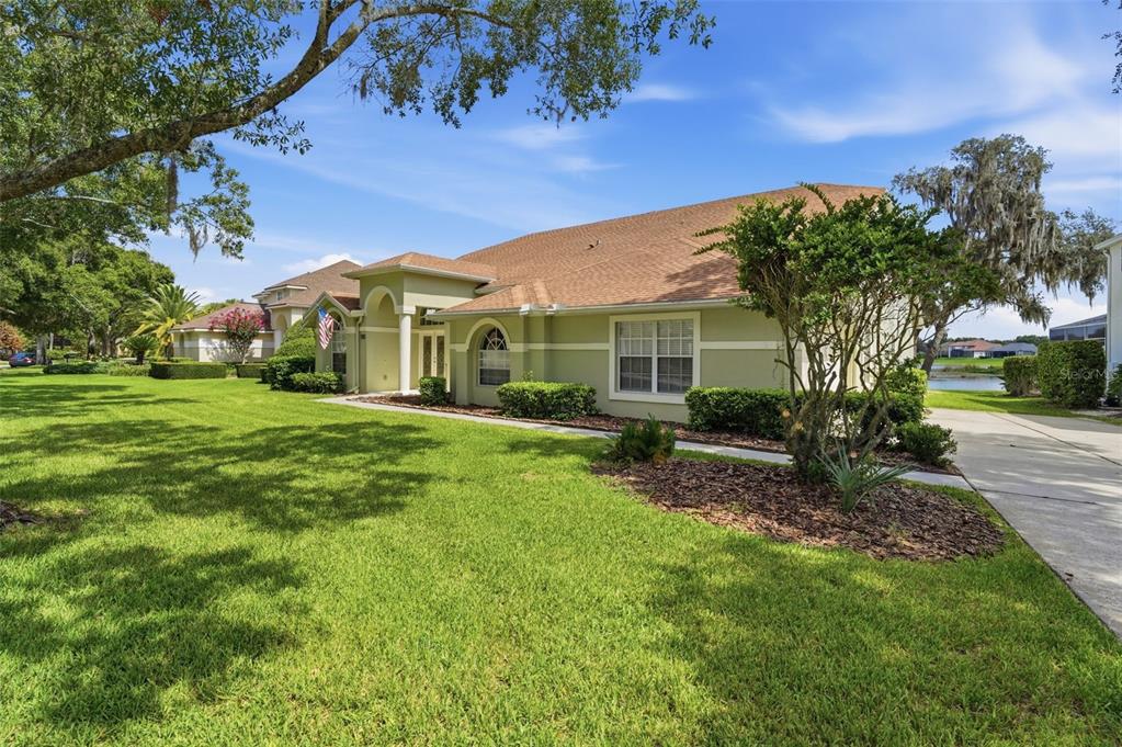 A light green single-story house with a brown shingled roof sits on a grassy lot — 1526 CHERRY LAKE WAY, LAKE MARY, FL