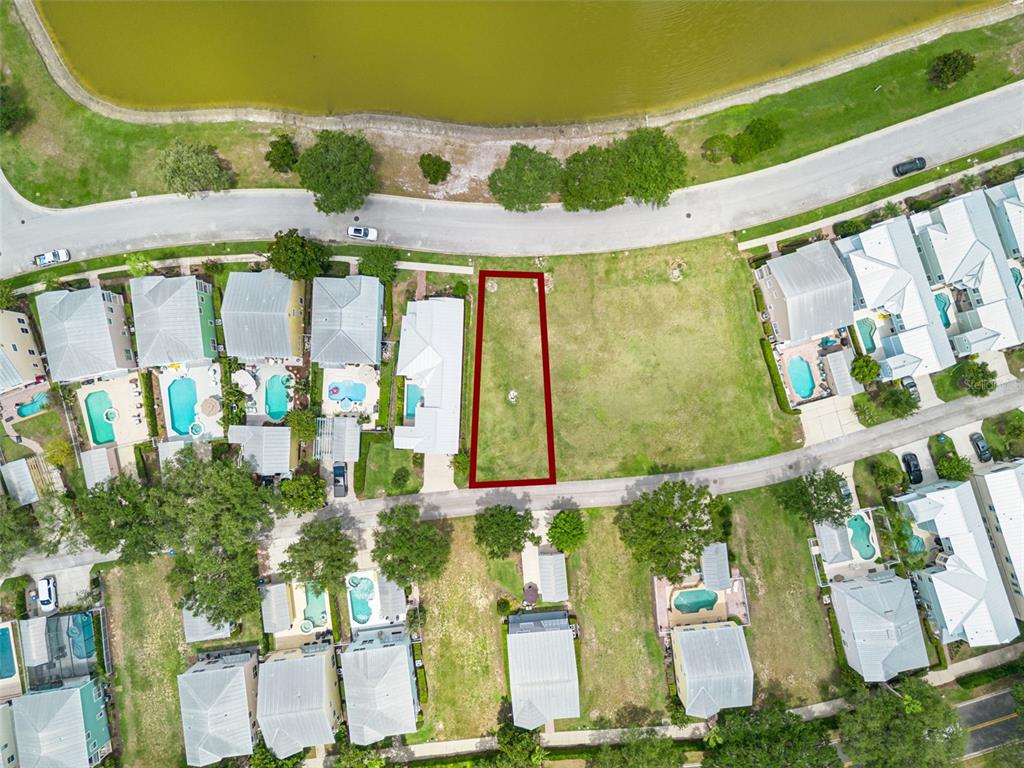 An aerial view shows a vacant rectangular residential lot outlined in red within a neighborhood — 1529 FAIRVIEW CIRCLE, REUNION, FL