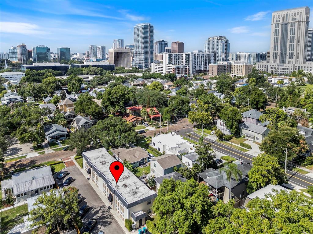 An aerial view shows a flat-roofed building with a red location pin on its roof — 317 E AMELIA STREET UNIT 7, ORLANDO, FL