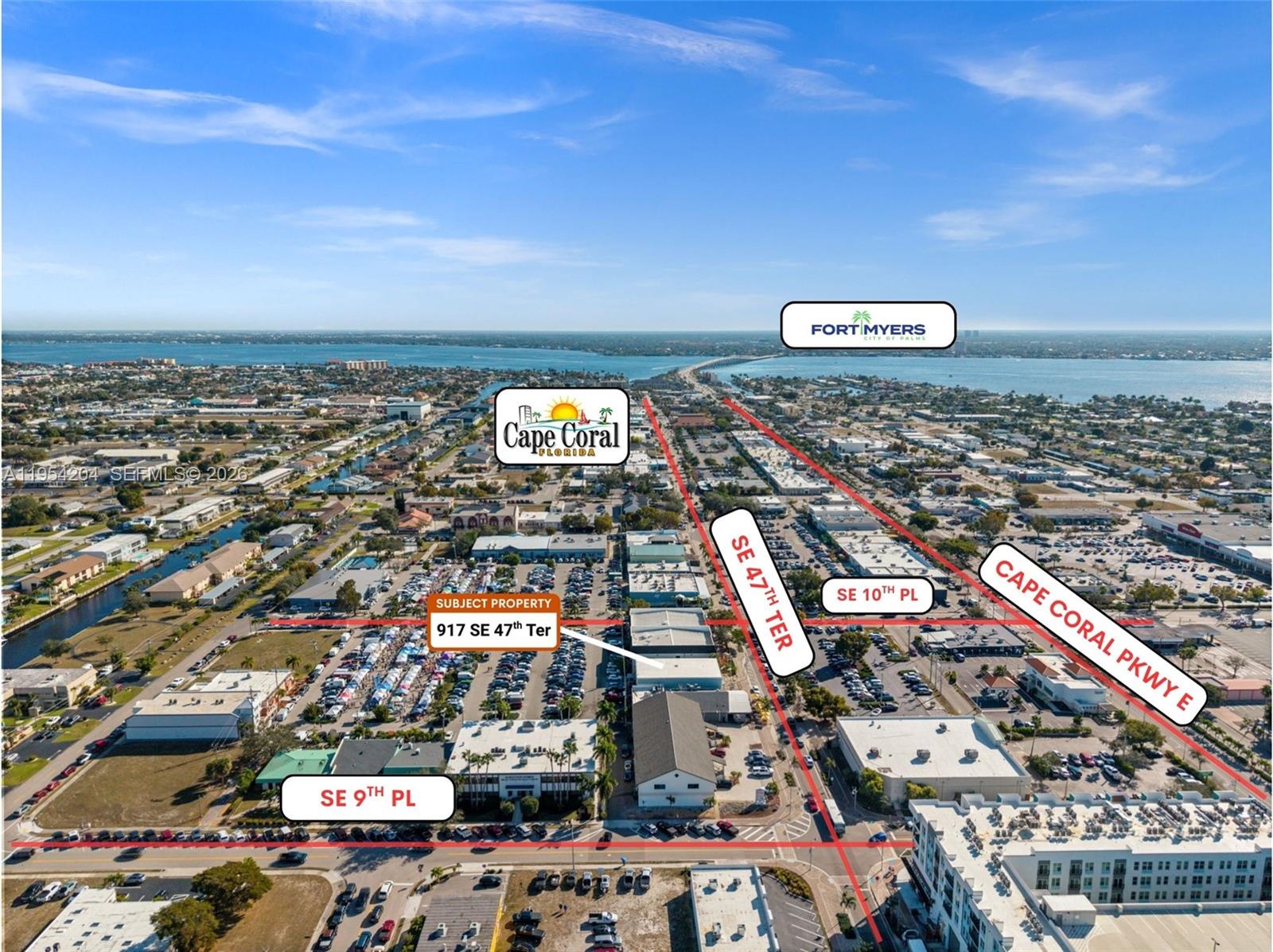 An aerial view shows a commercial property in a city with labeled streets and landmarks — 917 SE 47th Ter, Cape Coral FL 33904, CAPE CORAL, FL