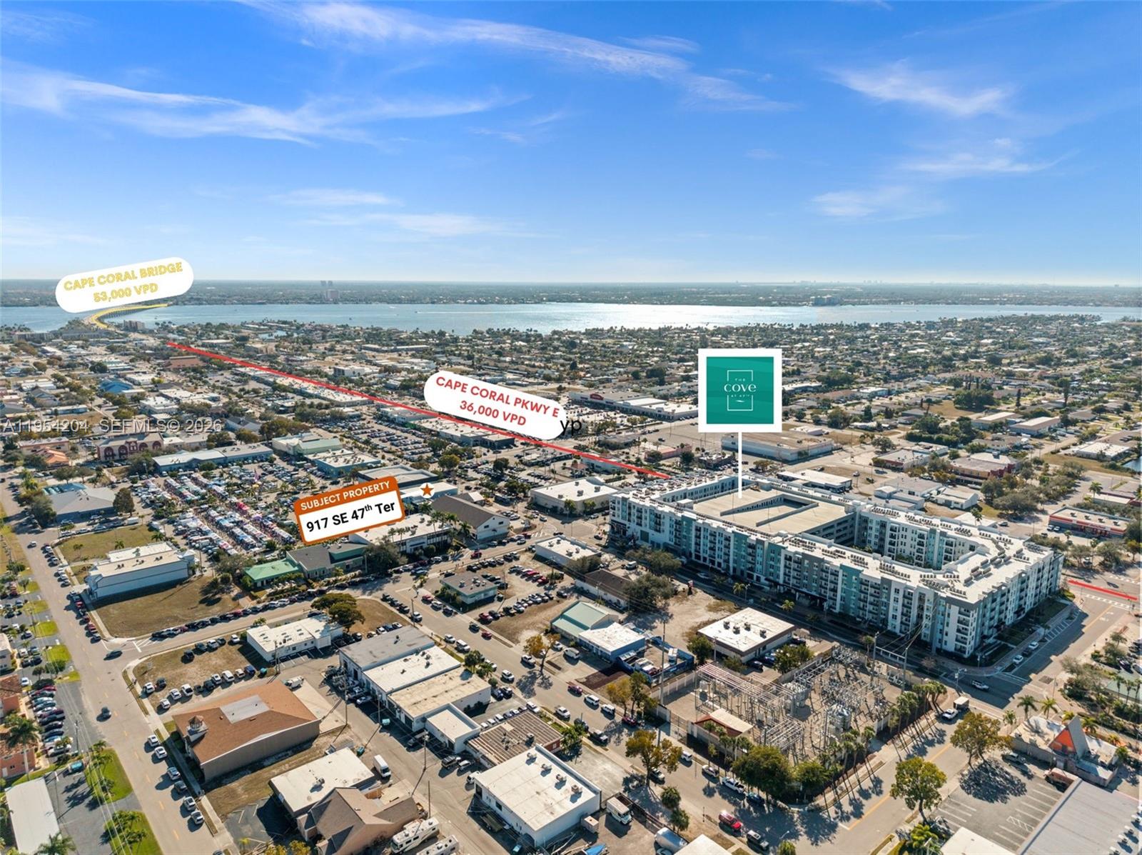This aerial view shows a commercial property and surrounding urban development in Cape Coral — 917 SE 47th Ter, Cape Coral FL 33904, CAPE CORAL, FL