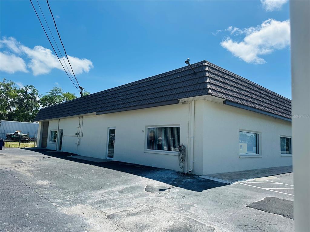 A low-rise commercial building with a dark mansard roof and a paved parking lot — 7904 US HIGHWAY 19, PORT RICHEY, FL