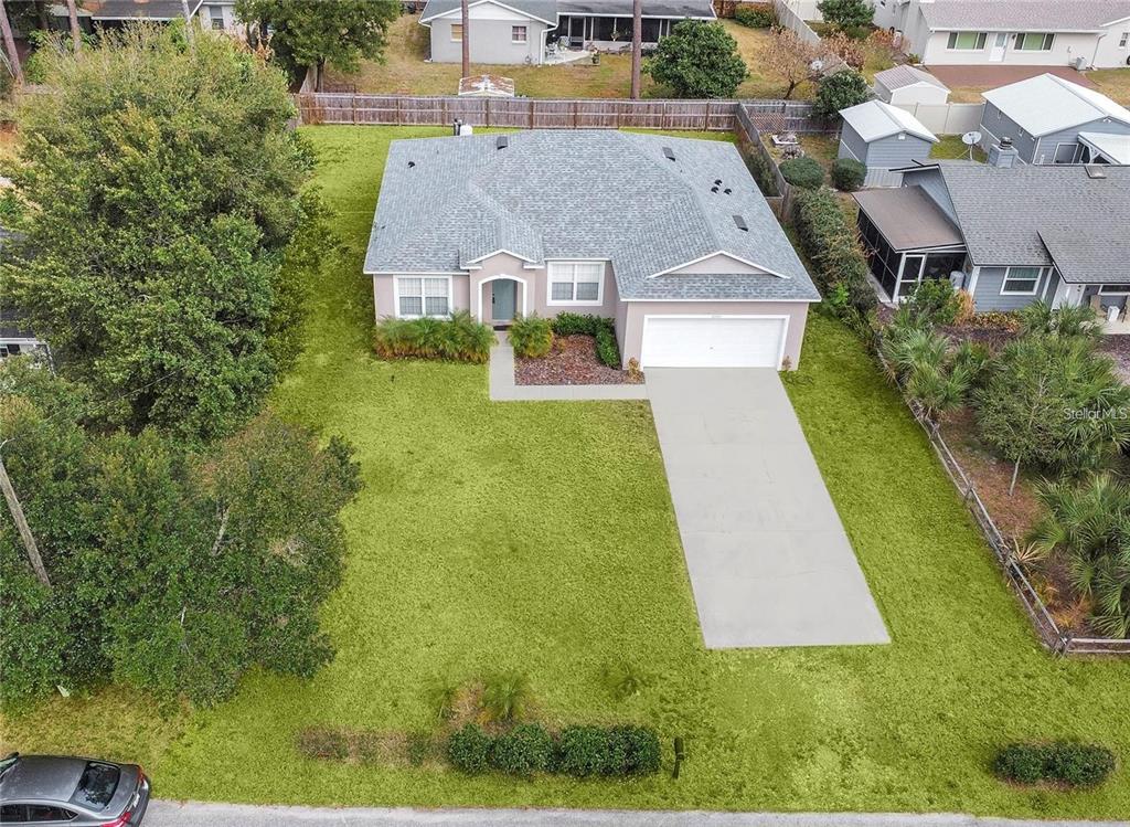 An aerial view shows a single-story house with a gray roof, garage, and large lawn — 2727 RAMSEY DRIVE, APOPKA, FL