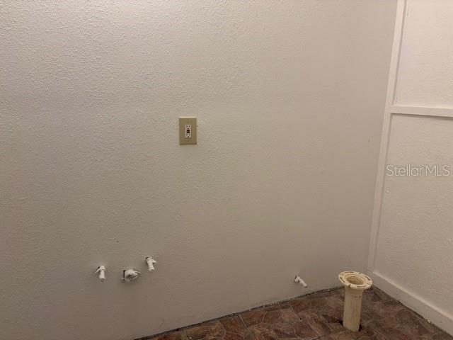 A laundry room area features plumbing hookups, a floor drain, and a wall-mounted electrical outlet — 6419 SE 215TH STREET, HAWTHORNE, FL