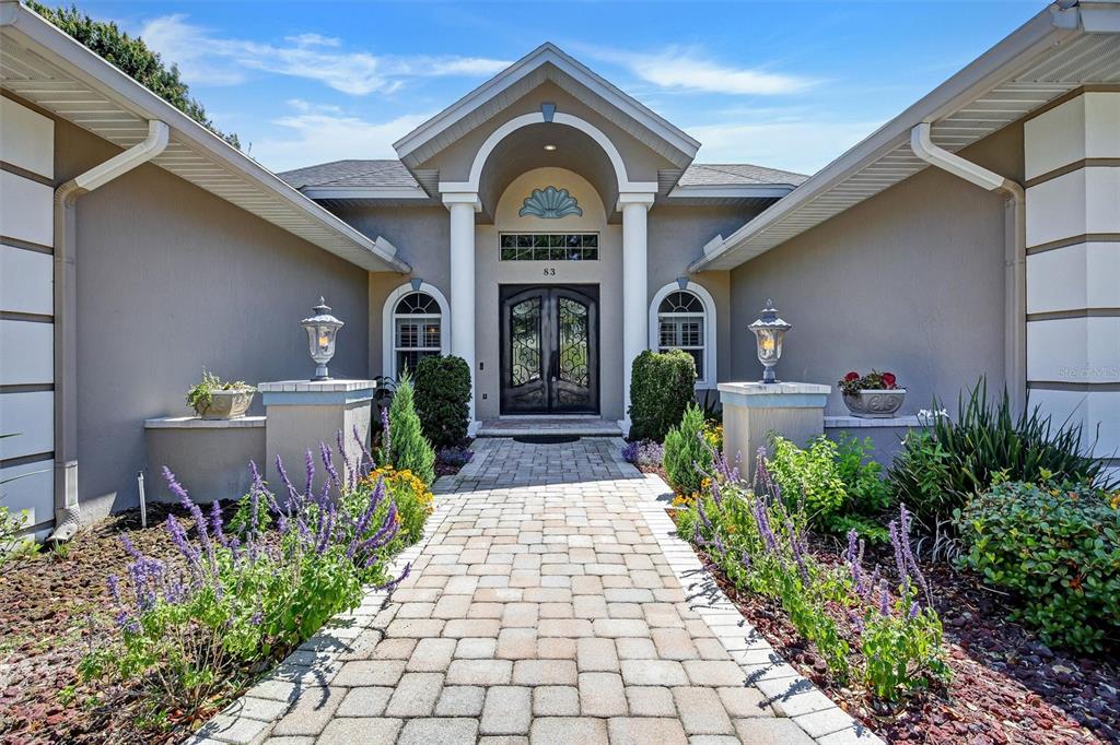 A single-story house with a circular driveway, palm tree, and landscaped front yard — 83 JENNI ASHLEY COURT, WINTER HAVEN, FL