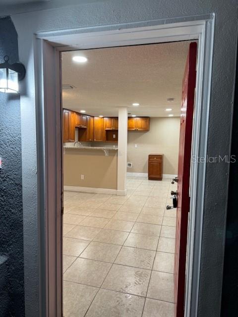 A view through a doorway shows a kitchen with wooden cabinets and tiled floors — 2847 W HARWOOD STREET, ORLANDO, FL
