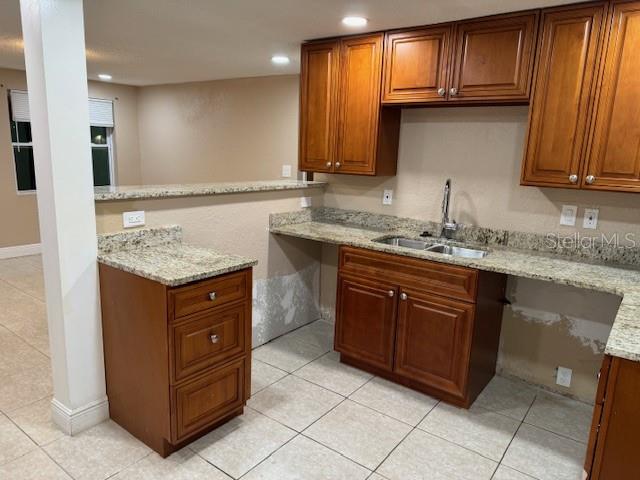 A kitchen with wood cabinets, granite countertops, and a stainless steel sink — 2847 W HARWOOD STREET, ORLANDO, FL