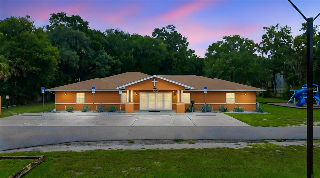 A single-story orange building with a cross above the entrance and a parking lot — 3075 N GOLDENROD ROAD, WINTER PARK, FL