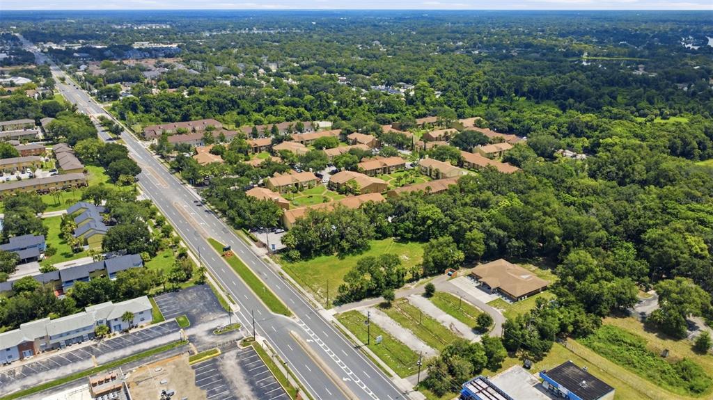 An aerial view shows a multi-family apartment complex situated next to a multi-lane road — 3075 N GOLDENROD ROAD, WINTER PARK, FL