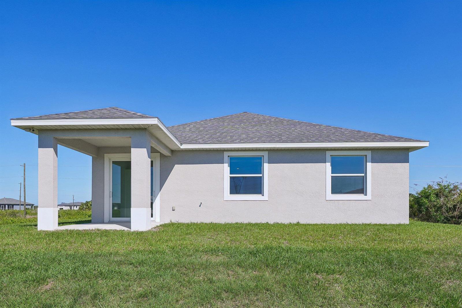 The exterior view shows the back of a single-story house with a covered patio — 9006 S Castle Circle, FL 33935, FL