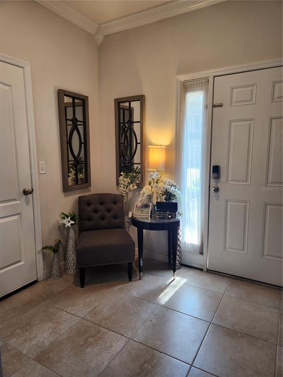 An entryway features a tufted chair, a side table with a lamp, and two wall mirrors — 3901 SILVERLAKE WAY, WESLEY CHAPEL, FL