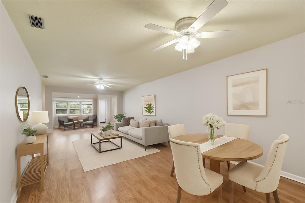 This is a digital rendering of an open-concept living and dining room with wood flooring — 11200 102ND AVENUE UNIT 33, SEMINOLE, FL