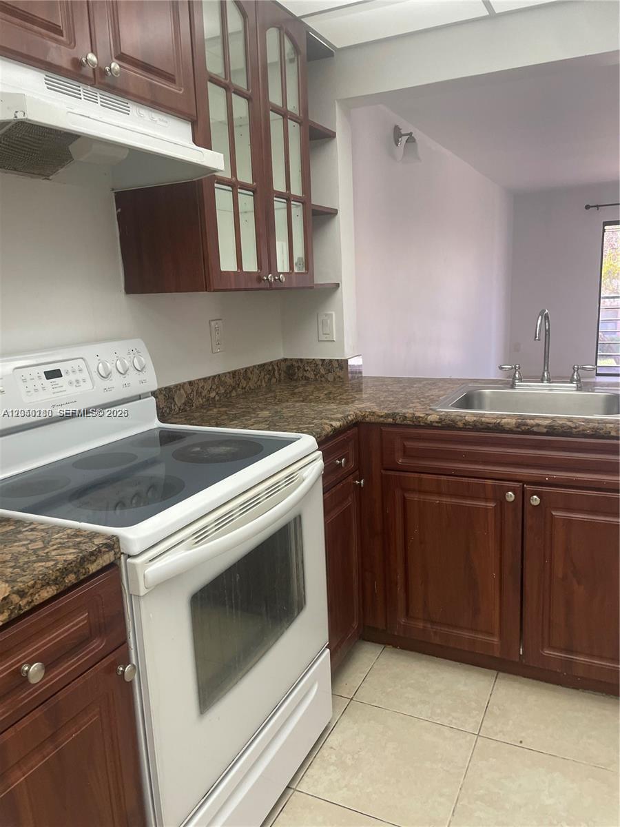 A bright bedroom features a bed with neutral bedding, a wall-mounted nightstand, and large windows — 20825 NE 8th Ct # 19, Miami FL 33179, MIAMI, FL