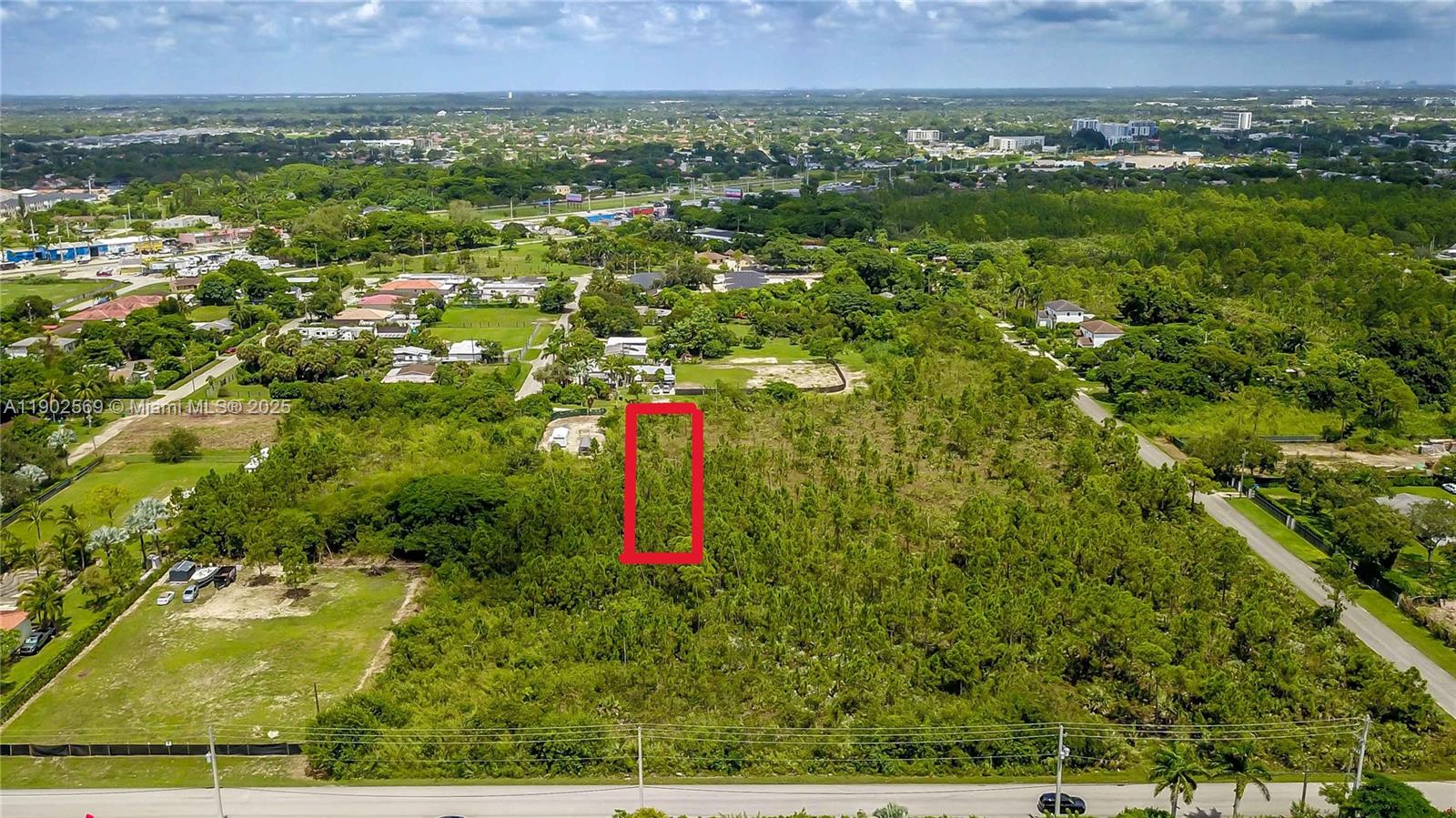 An aerial view shows a rectangular red outline marking a vacant, tree-covered lot — 12251 SW 230th Street, Miami FL 33170, MIAMI, FL