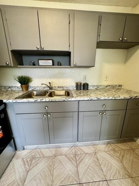 A kitchen features gray cabinets, a granite countertop, a stainless steel sink, and tiled flooring — 116 N F Street # 7, FL 33460, FL