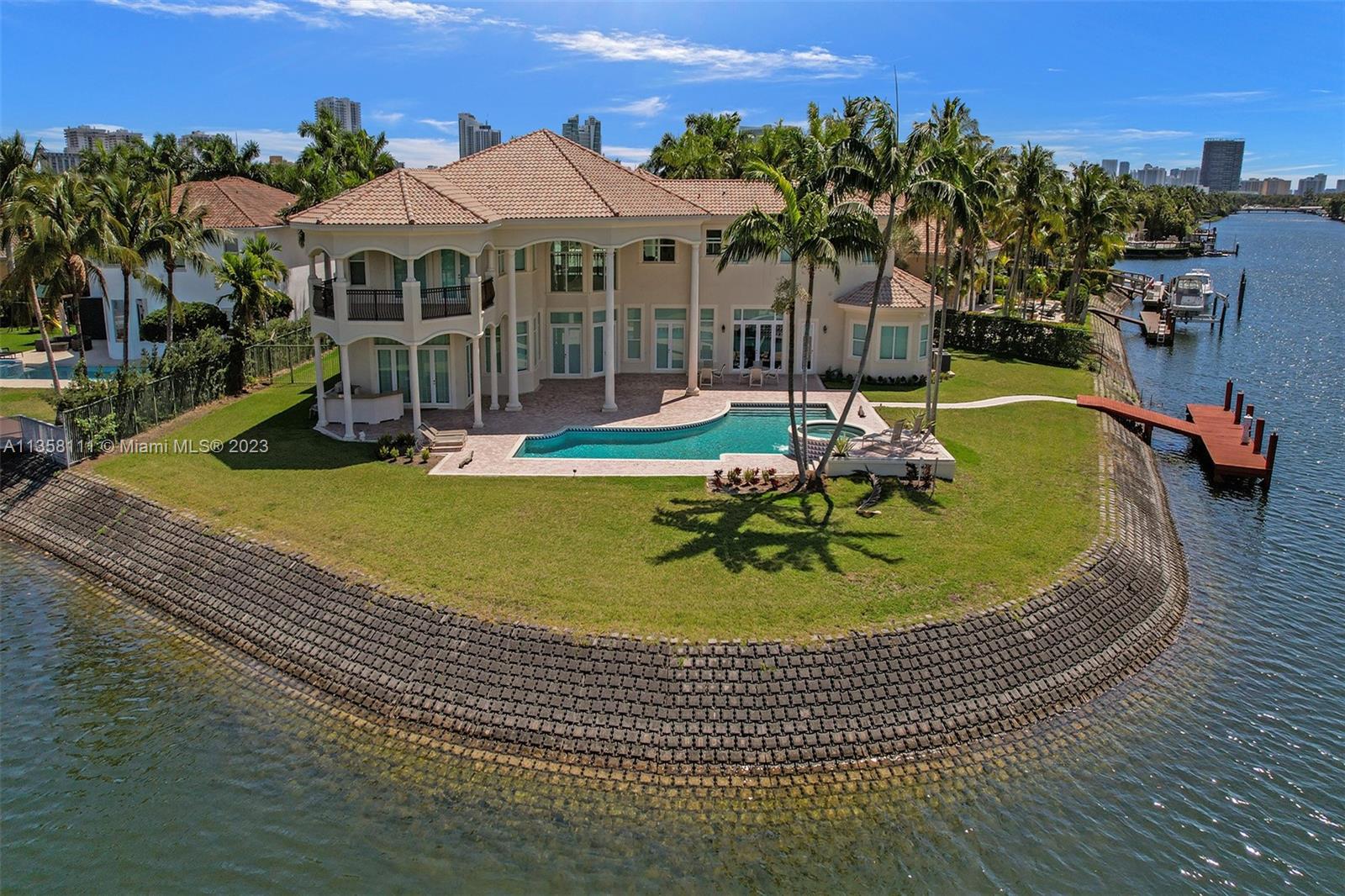 An aerial view shows a two-story waterfront house with a pool and a private dock — 1130 Harbor Ct, Hollywood FL 33019, HOLLYWOOD, FL