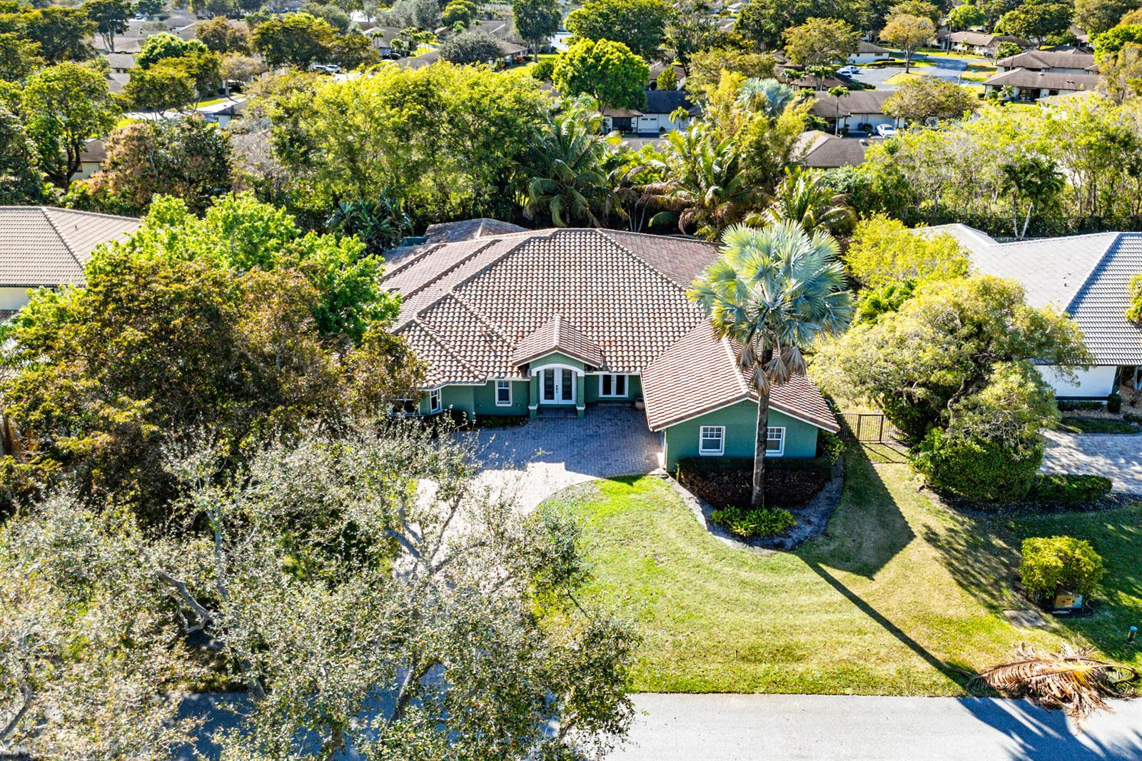 An aerial view shows a green house with a tiled roof and a palm tree — 10295 Saint Andrews Road, Boynton Beach FL 33436, BOYNTON BEACH, FL