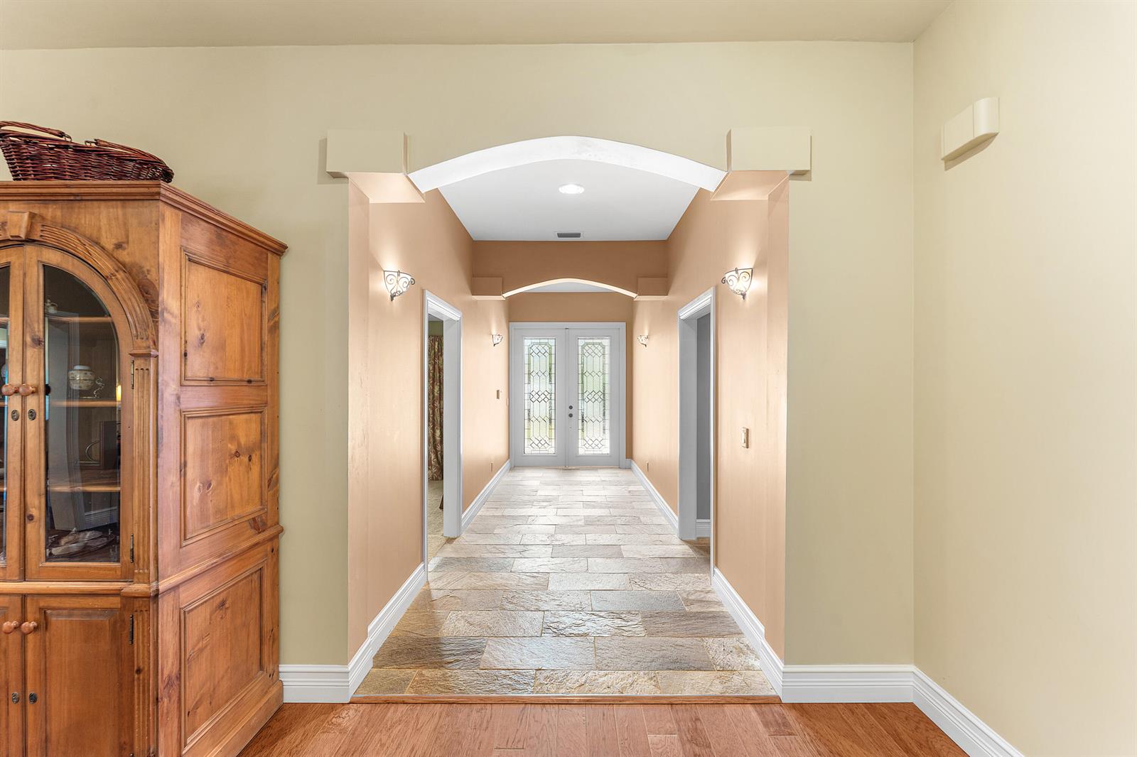 A tiled hallway with arched ceilings leads to a double-door entryway in a home — 10295 Saint Andrews Road, Boynton Beach FL 33436, BOYNTON BEACH, FL