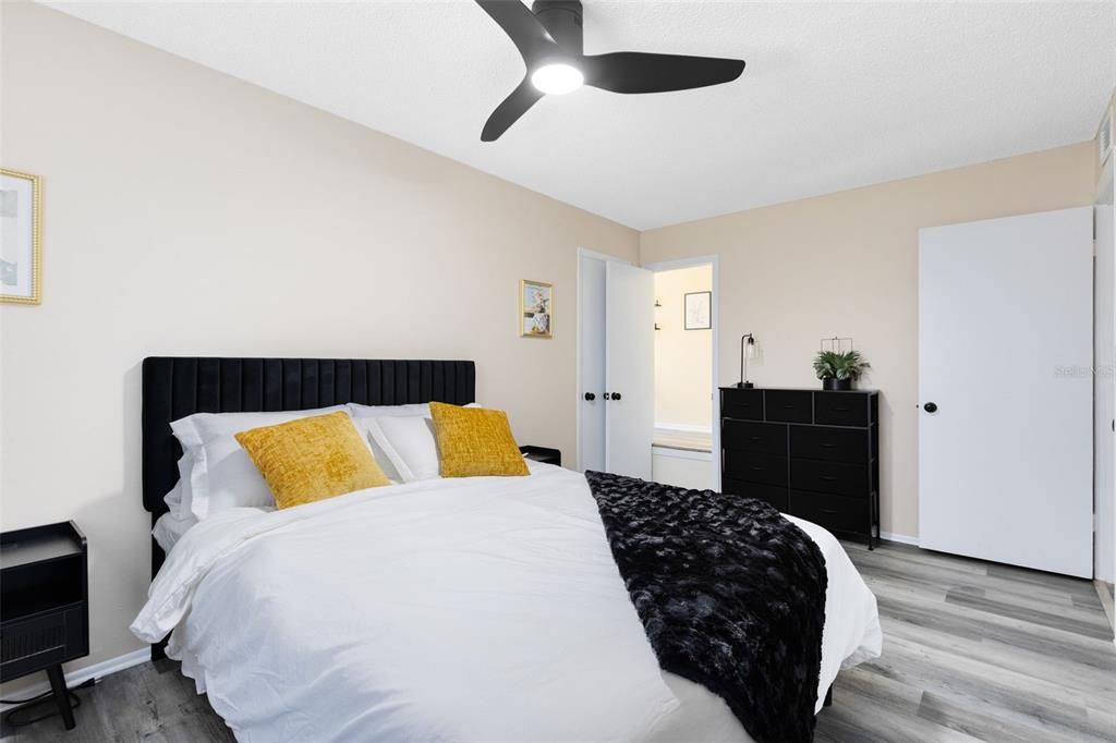 A kitchen features white cabinets, a white refrigerator, a white stove, and a white island — 1228 E MURIEL STREET, ORLANDO, FL