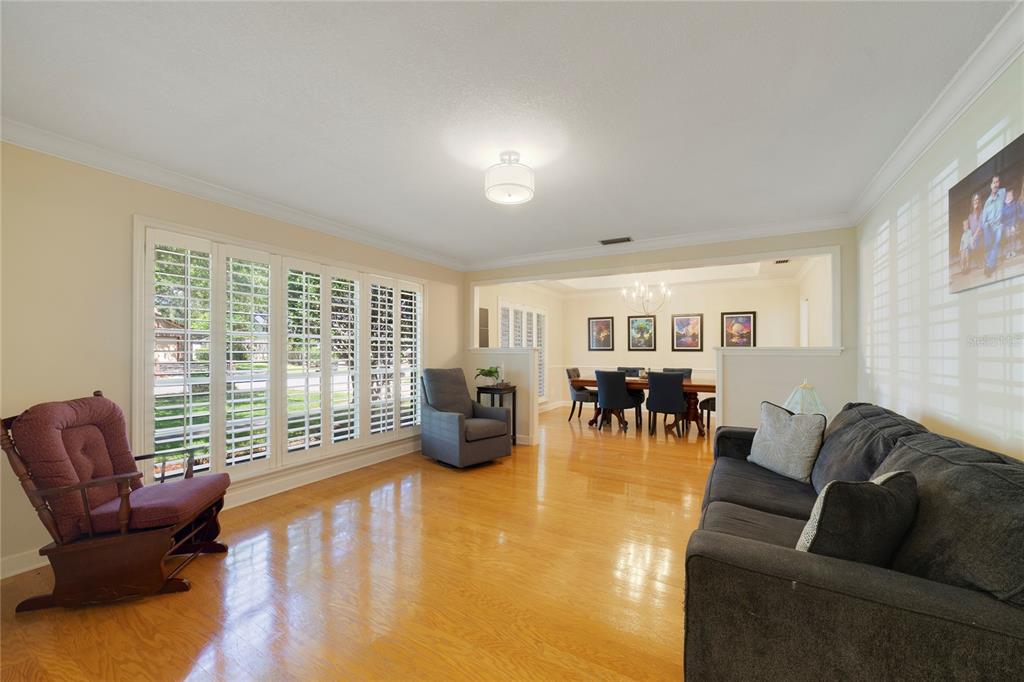 A dining room with a tray ceiling, hardwood floors, and a dark wood table — 749 WILLOW RUN LANE, WINTER SPRINGS, FL