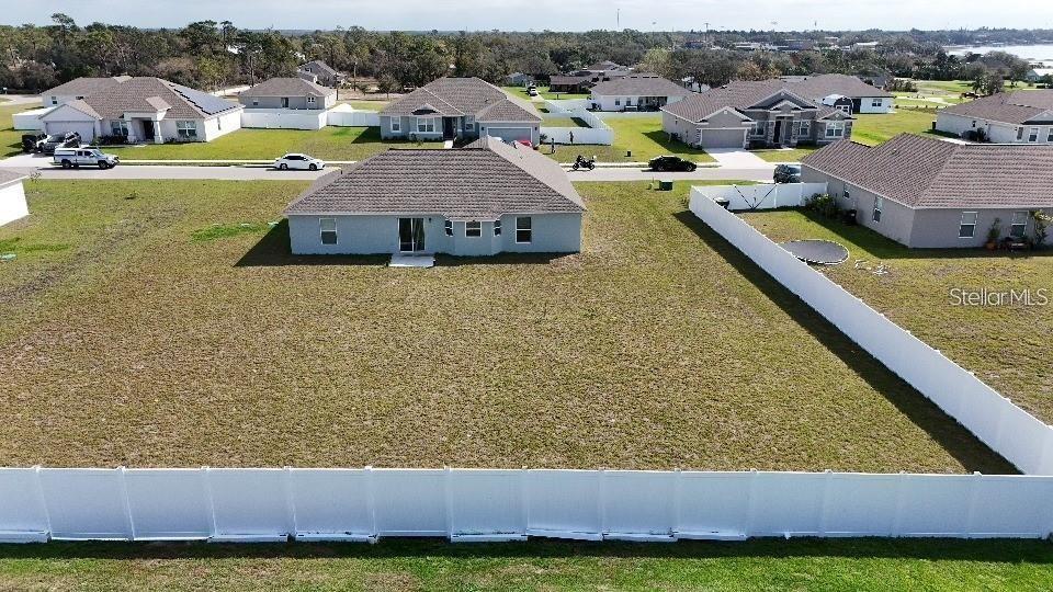 An aerial view shows a suburban house with a large fenced backyard — 1116 CALOOSA RIDGE WAY, BABSON PARK, FL