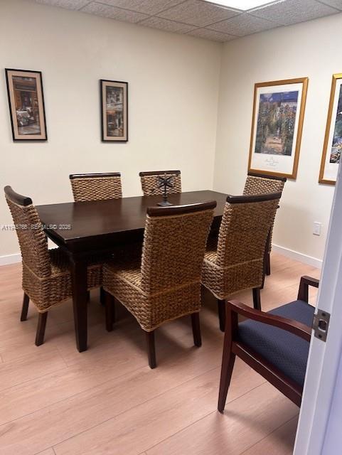 A dining room features a dark wood table with six woven chairs on light flooring — 13318 SW 128th St, Miami FL 33186, MIAMI, FL