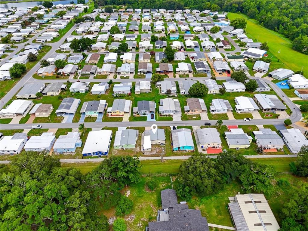 An aerial view of a dense residential neighborhood featuring many manufactured homes and green spaces — 1794 FOX HILL DRIVE, LAKELAND, FL