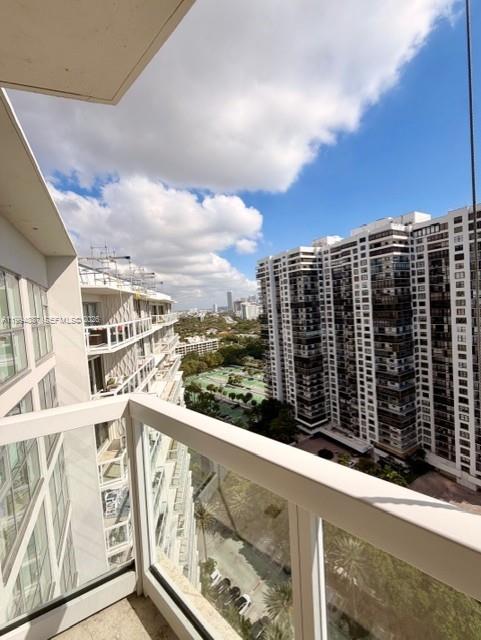 A high-angle view from a balcony overlooks a city street and neighboring high-rise apartment buildings — 2451 Brickell Ave, Miami FL 33129, MIAMI, FL