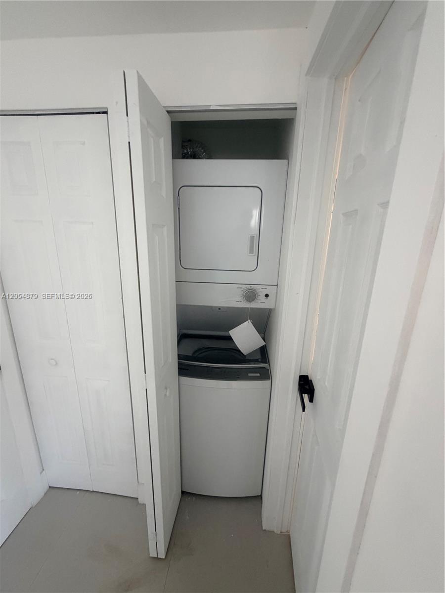 A stacked washer and dryer unit is located inside a small closet — 43 Williams Rd # 3, West Park FL 33023, WEST PARK, FL