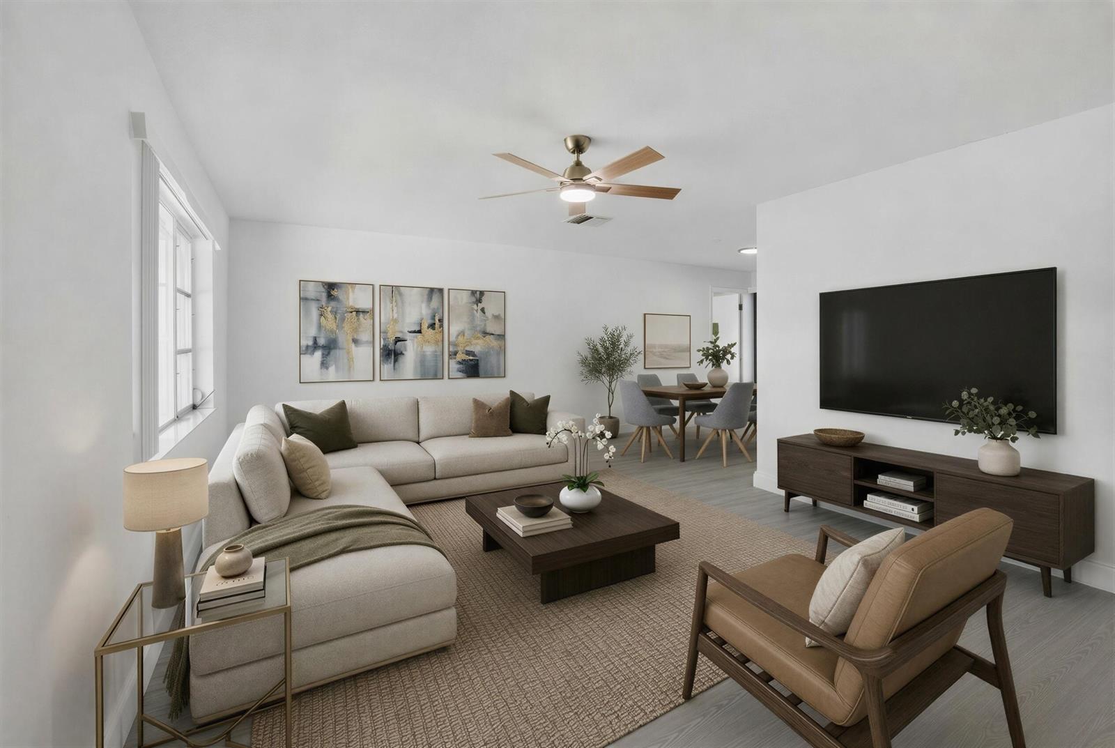 This digital rendering shows a modern living room with a sectional sofa and dining area — 703 SW 18th Street, Boynton Beach FL 33426, BOYNTON BEACH, FL