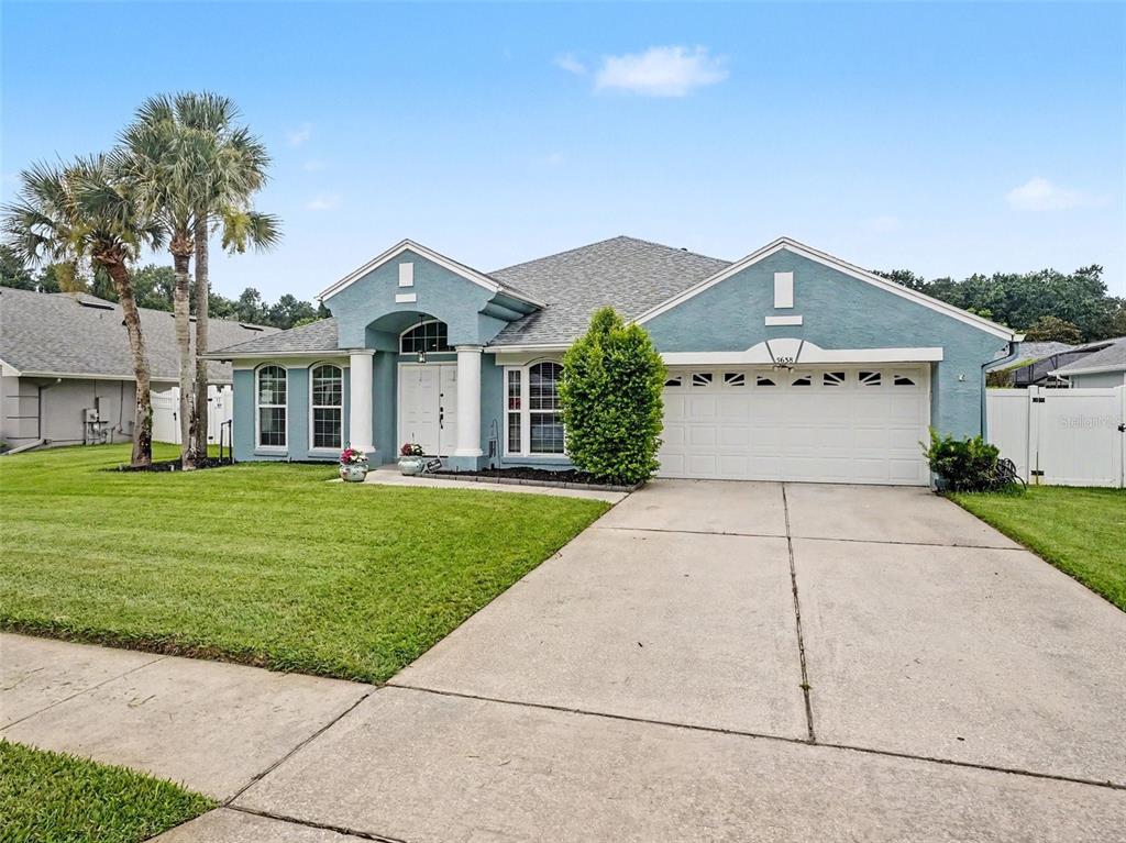 A blue single-story house with a white garage, front columns, and a grassy lawn — 5638 CATSKILL COURT, WINTER SPRINGS, FL