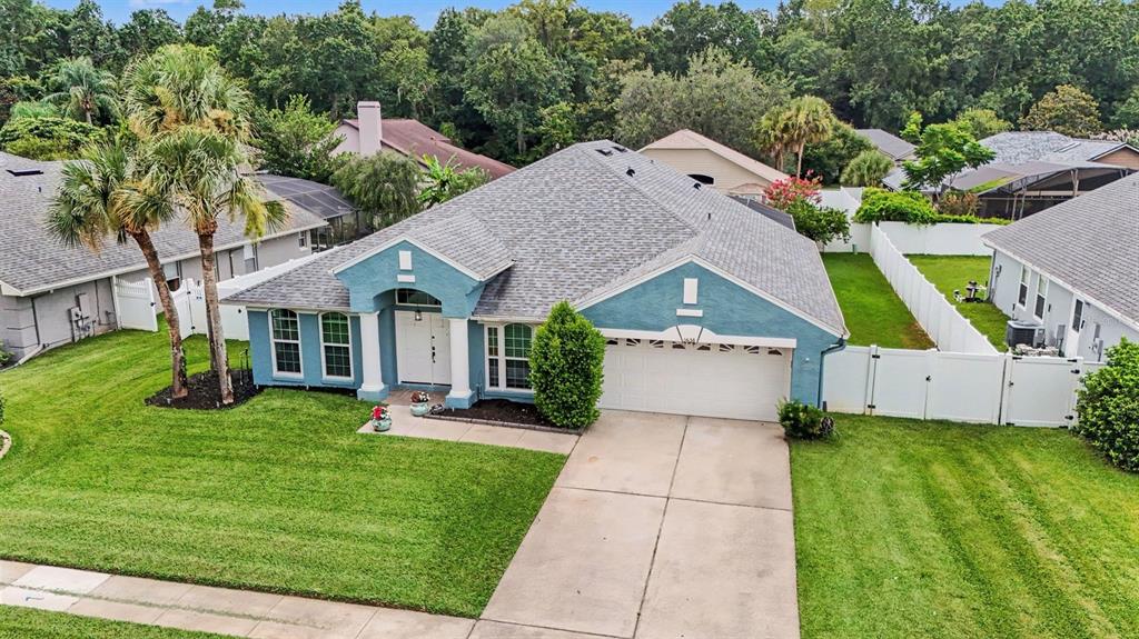 An aerial view of a blue single-story house with a two-car garage and palm trees — 5638 CATSKILL COURT, WINTER SPRINGS, FL