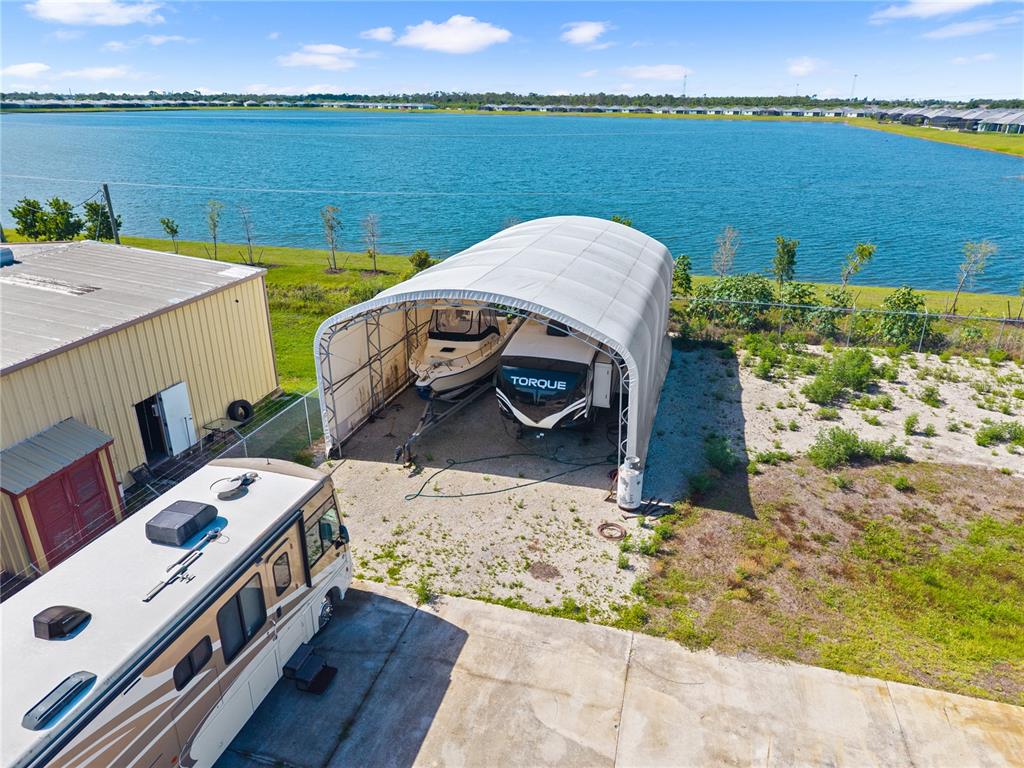 An aerial view shows a large metal storage shelter housing a boat and camper — 2640 AVENUE OF THE AMERICAS, ENGLEWOOD, FL
