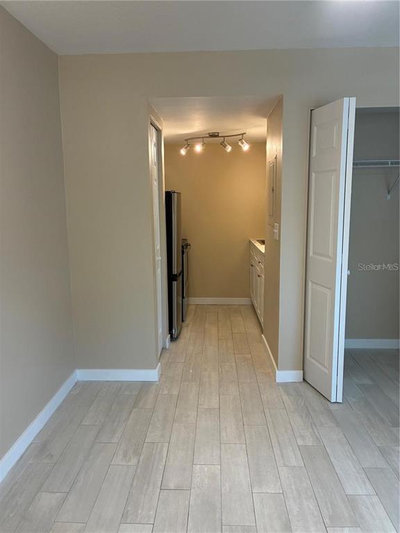 A view of a kitchen area with light-colored tile flooring and a white closet door — 4131 DOLPHIN DRIVE UNIT 4131, TAMPA, FL