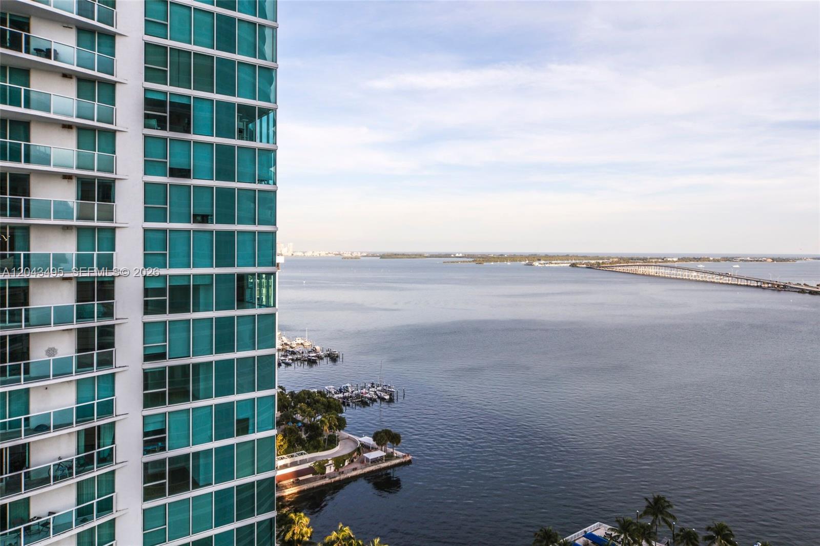 A high-rise building overlooks a bay with a bridge and a small marina — 2127 Brickell Ave # 2504, Miami FL 33129, MIAMI, FL