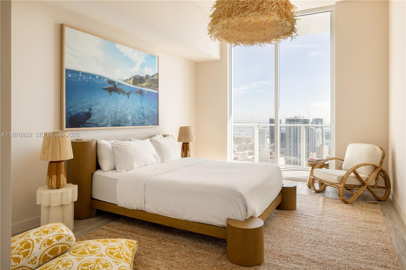 A modern bedroom features a platform bed, a large ocean artwork, and floor-to-ceiling city views — 275 SW 6th St # 2006, Miami FL 33130, MIAMI, FL