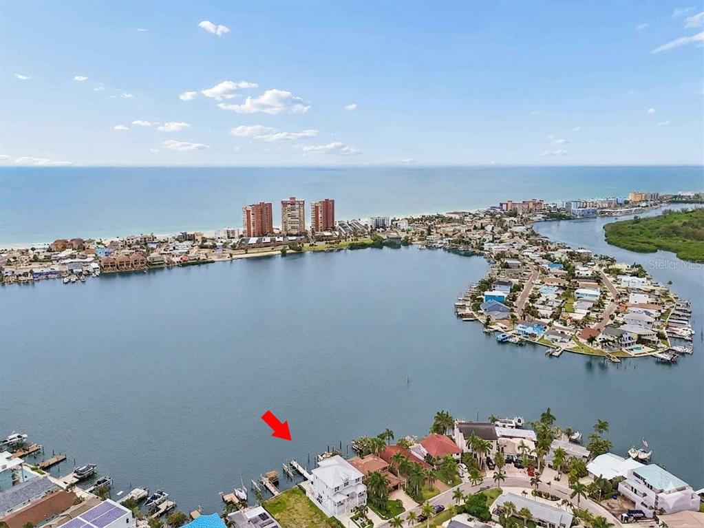 An aerial view of a waterfront home with a private dock on a bay — 17715 WALL CIRCLE, REDINGTON SHORES, FL