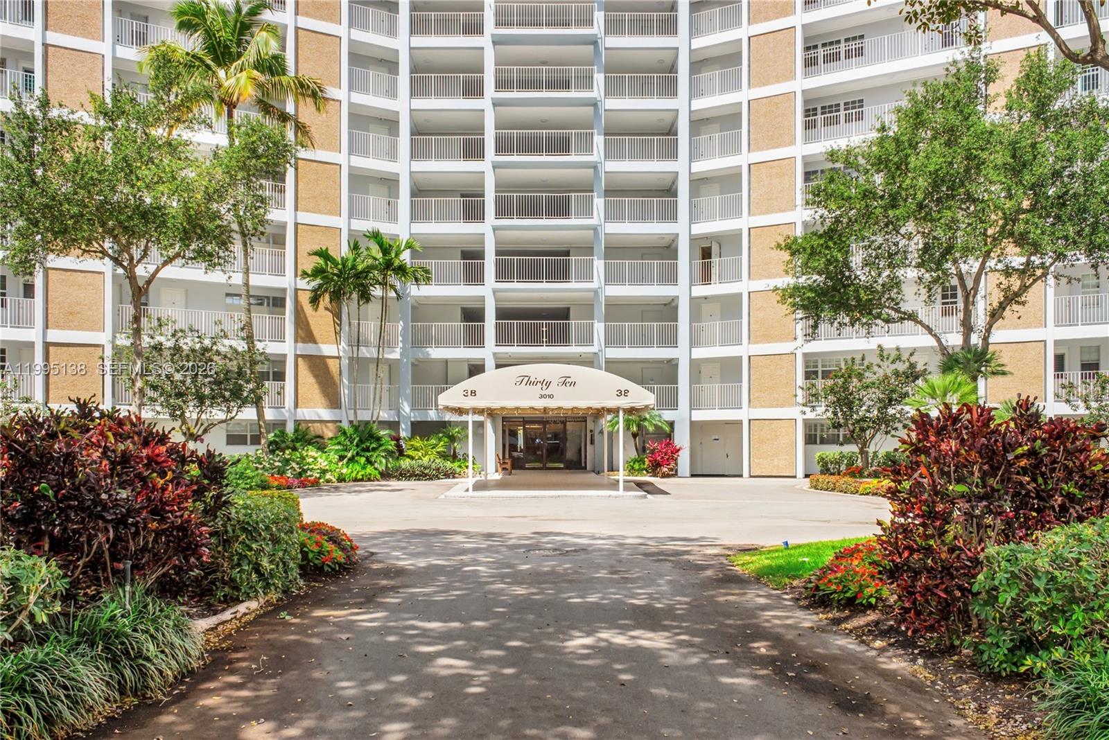 A multi-story apartment building features a covered entrance with a sign reading Thirty Ten — 3010 N Course Dr # 104, Pompano Beach FL 33069, POMPANO BEACH, FL
