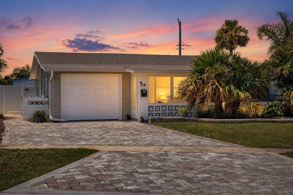 A single-story house with a white garage door, paved driveway, and decorative concrete block wall — 6 TROPICAL DRIVE, ORMOND BEACH, FL