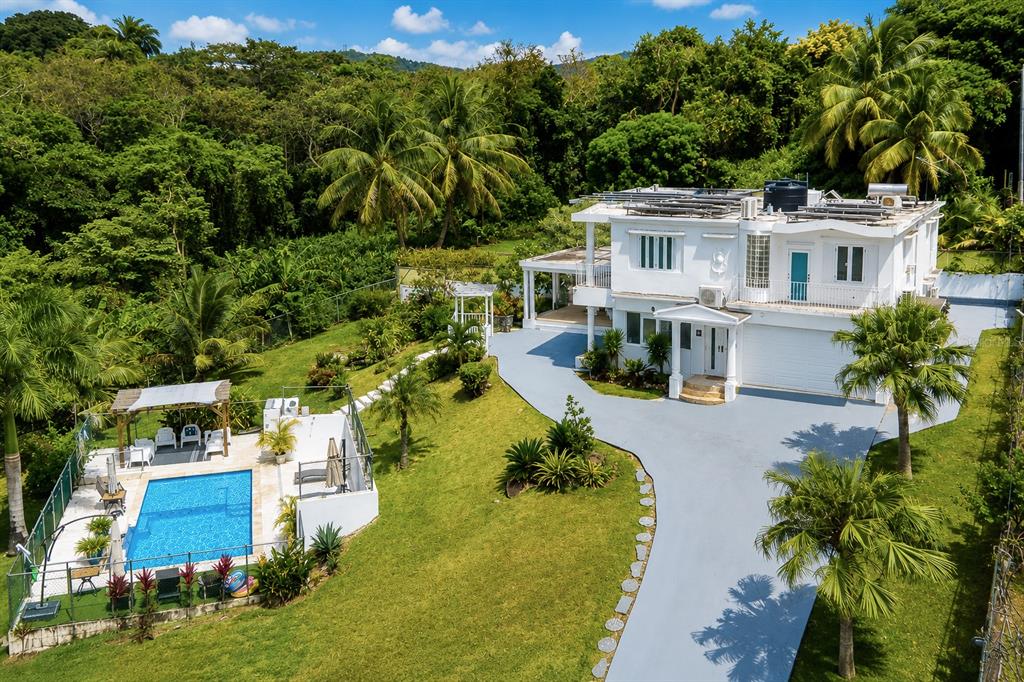 An aerial view of a white two-story house with a swimming pool and lush landscaping — Km 25 Hm 9 Carr 3 JIMENEZ 4E, RIO GRANDE, PR