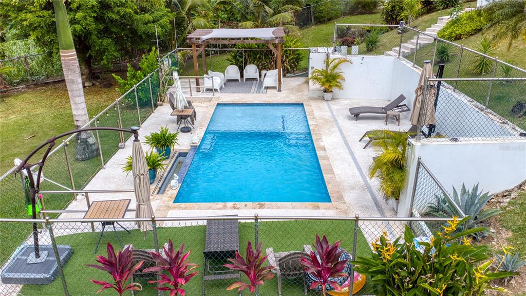 An elevated view of a rectangular swimming pool surrounded by a patio and landscaping — Km 25 Hm 9 Carr 3 JIMENEZ 4E, RIO GRANDE, PR