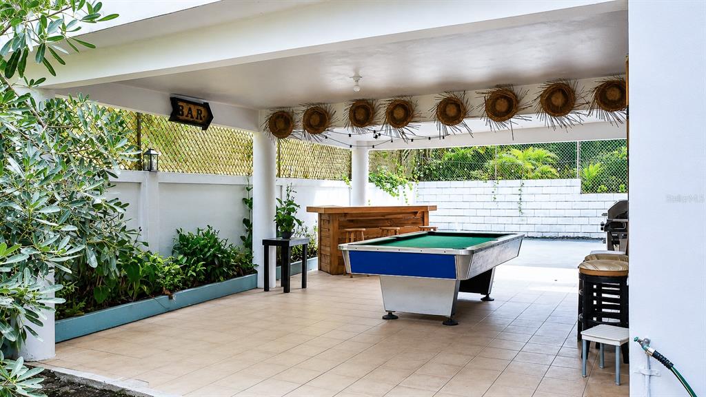 An outdoor covered patio features a pool table, a wooden bar, and decorative straw hats — Km 25 Hm 9 Carr 3 JIMENEZ 4E, RIO GRANDE, PR