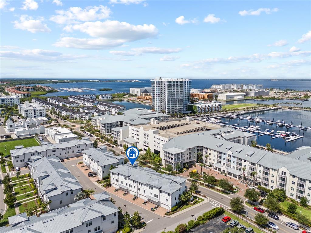 An aerial view shows a multi-story residential complex with a marina and water nearby — 5120 BRIDGE STREET UNIT 5, TAMPA, FL