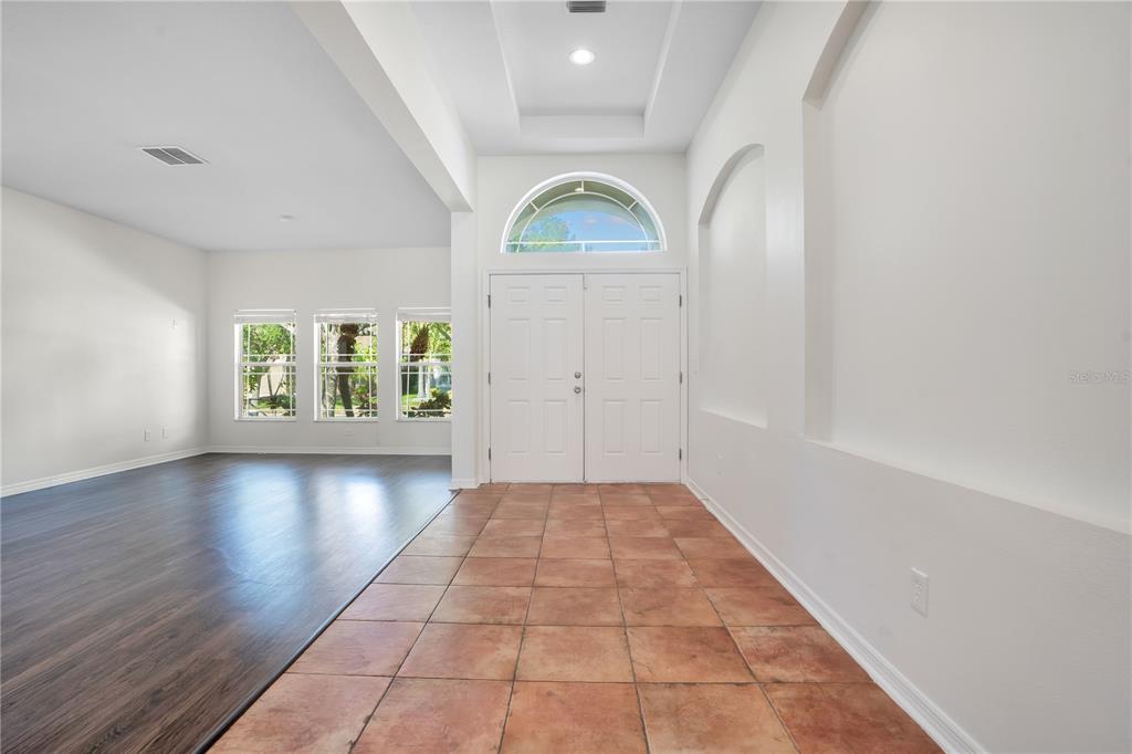An entryway with tile flooring leads to double front doors with an arched transom window — 432 YORK DALE DRIVE, RUSKIN, FL