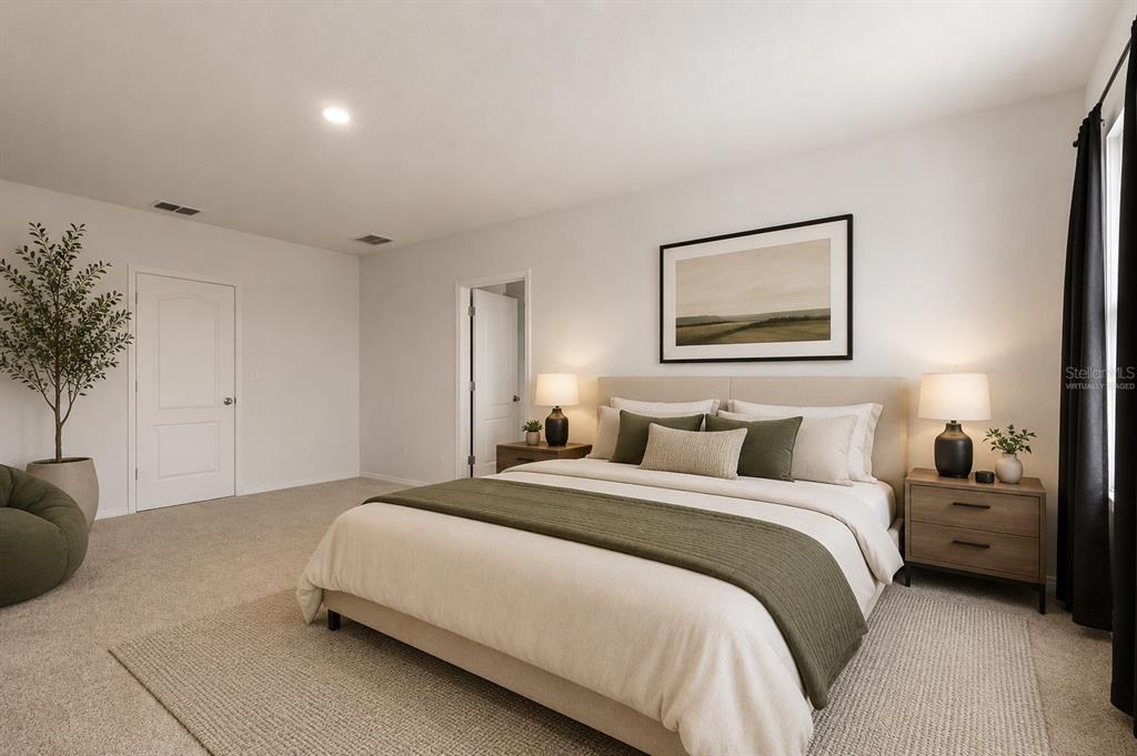 This bedroom features a bed with olive green accents, two nightstands, and a potted plant — 5125 FIDDLEWOOD WAY, ST CLOUD, FL