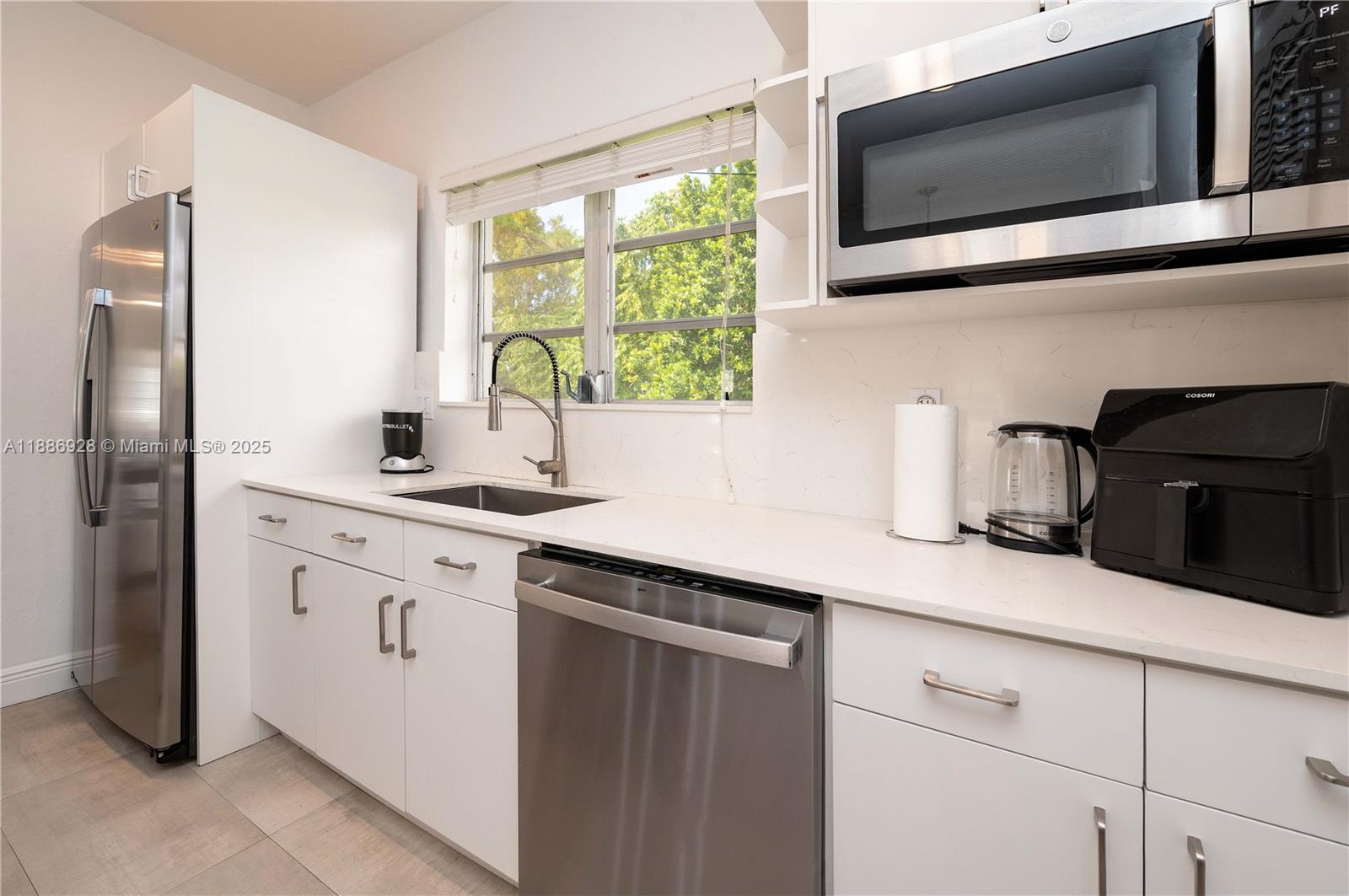 A modern kitchen features white cabinets, stainless steel appliances, and a window above the sink — 501 SW 24th Rd # 501, Miami FL 33129, MIAMI, FL